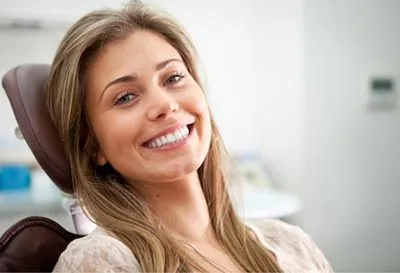 woman smiling during her dental appointment at Smiles on Elston