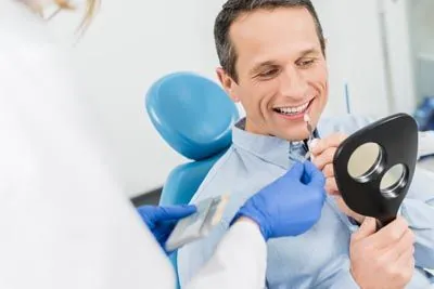 man choosing what color dental veneer he wants