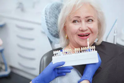 woman choosing which color she wants for dental veneers