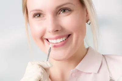 woman picking a color for her dental veneers