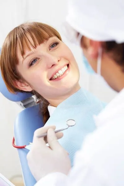woman receiving a dental checkup at Smiles on Elston