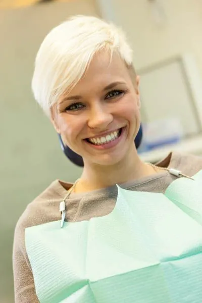 woman smiling in the dental chair at Smiles on Elston