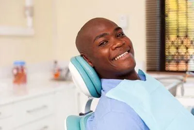 man smiling in the dental chair during his dental appointment at Smiles on Elston