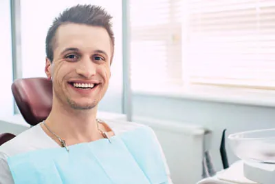 man smiling big after getting preventive dental care at Smiles on Elston